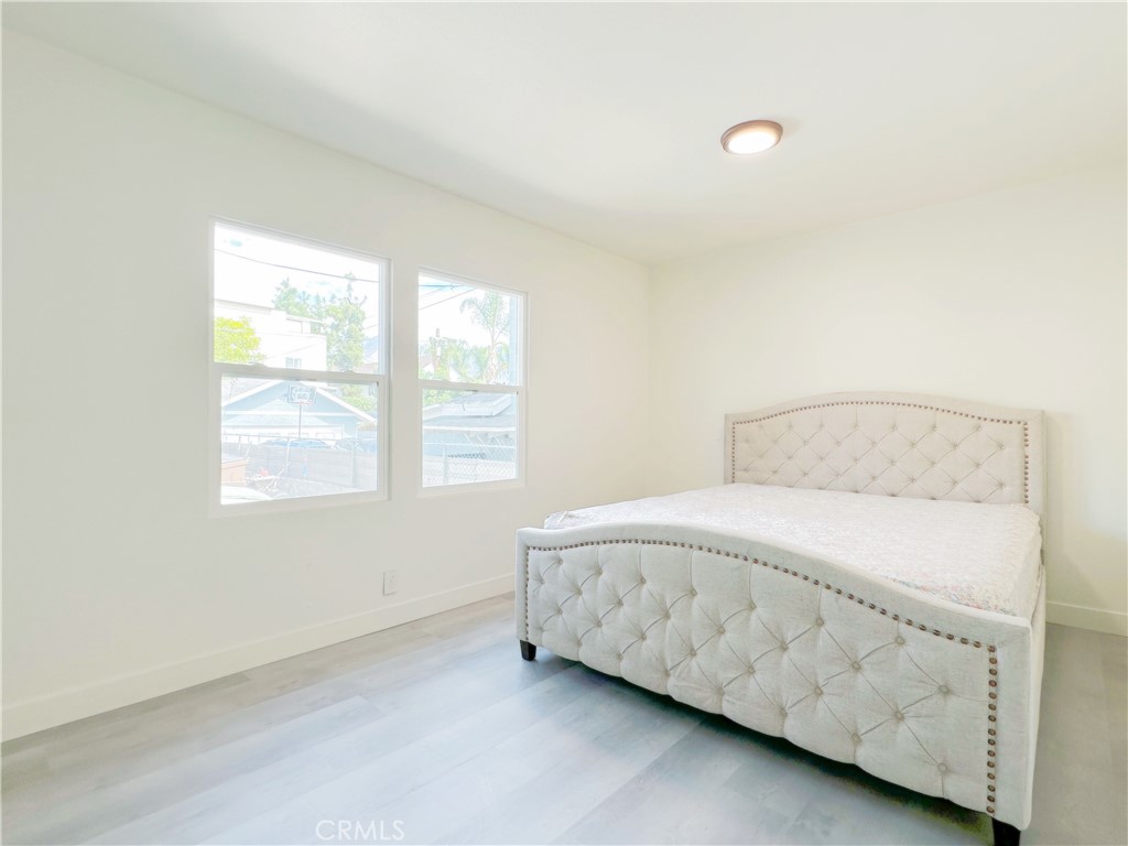 285 Parke Street Pasadena, CA 91101 - Photo 14 of 24 a bedroom with a bed and a window