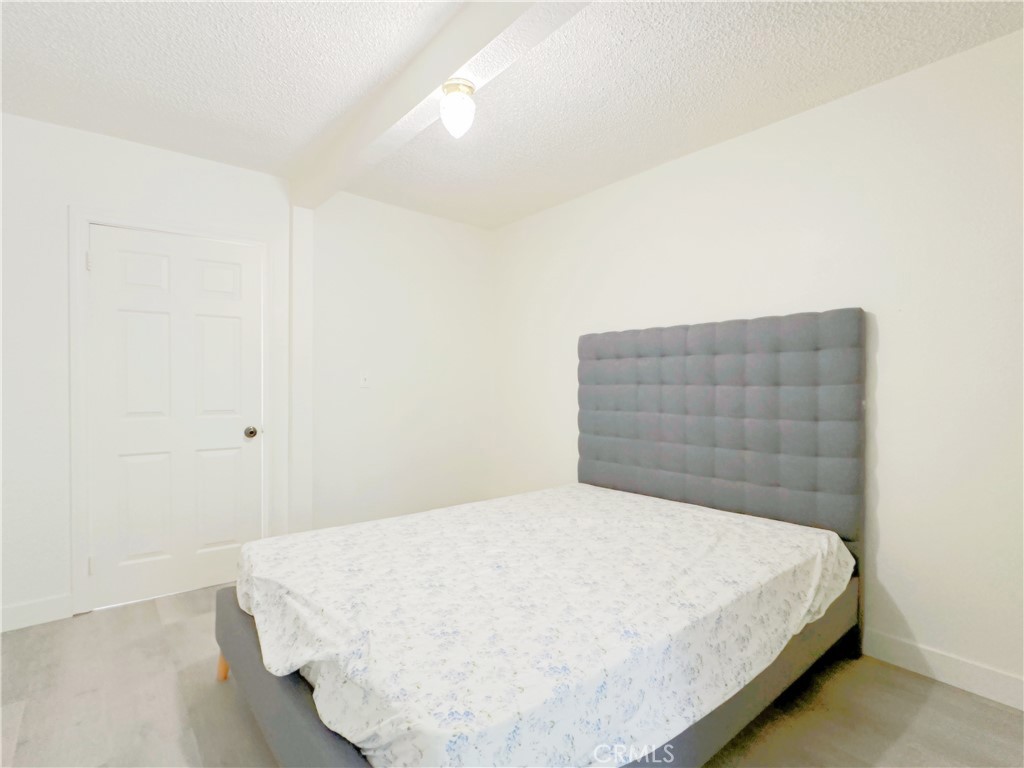 285 Parke Street Pasadena, CA 91101 - Photo 16 of 24 a bedroom with a bed and a window