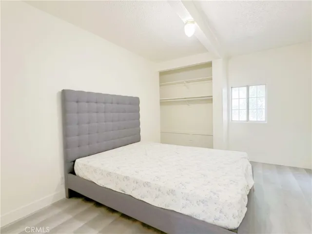 a bedroom with a bed and flowerpot