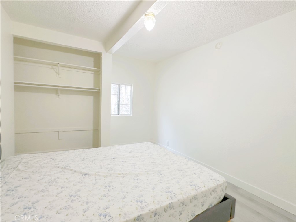 285 Parke Street Pasadena, CA 91101 - Photo 18 of 24 a bedroom with a bed and a window