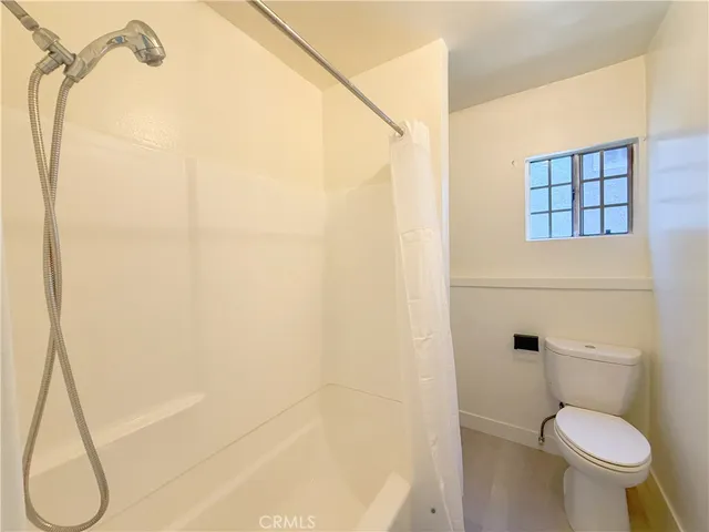 a bathroom with a toilet and a shower