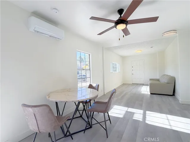 a view of a dining room with furniture and a window