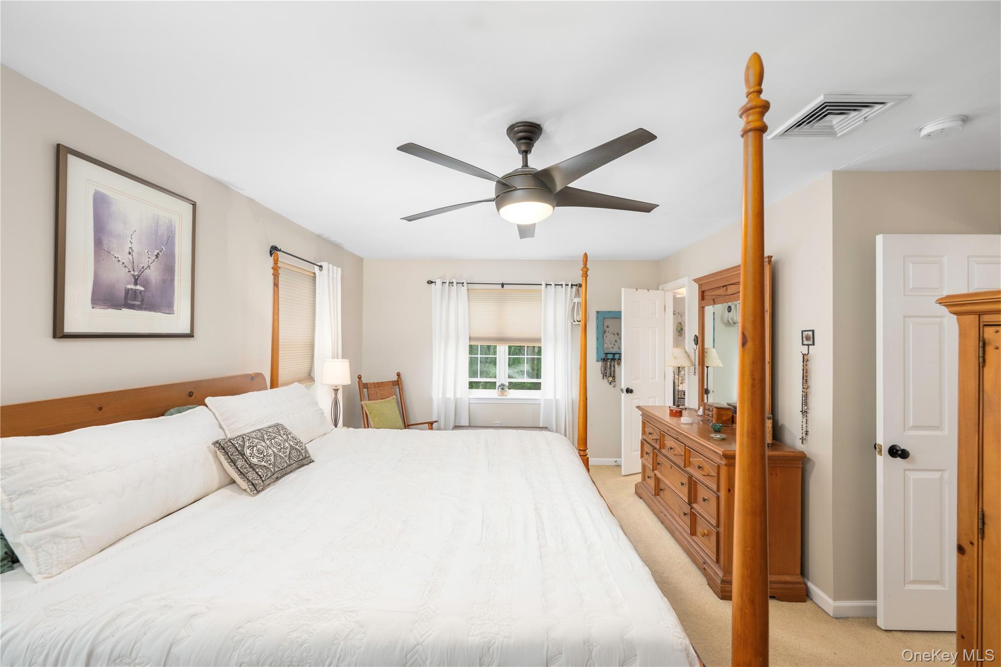 129 Stringham Road, Unit 31 LaGrangeville, NY 12540 - Photo 12 of 26 a spacious bedroom with a large bed and a chandelier