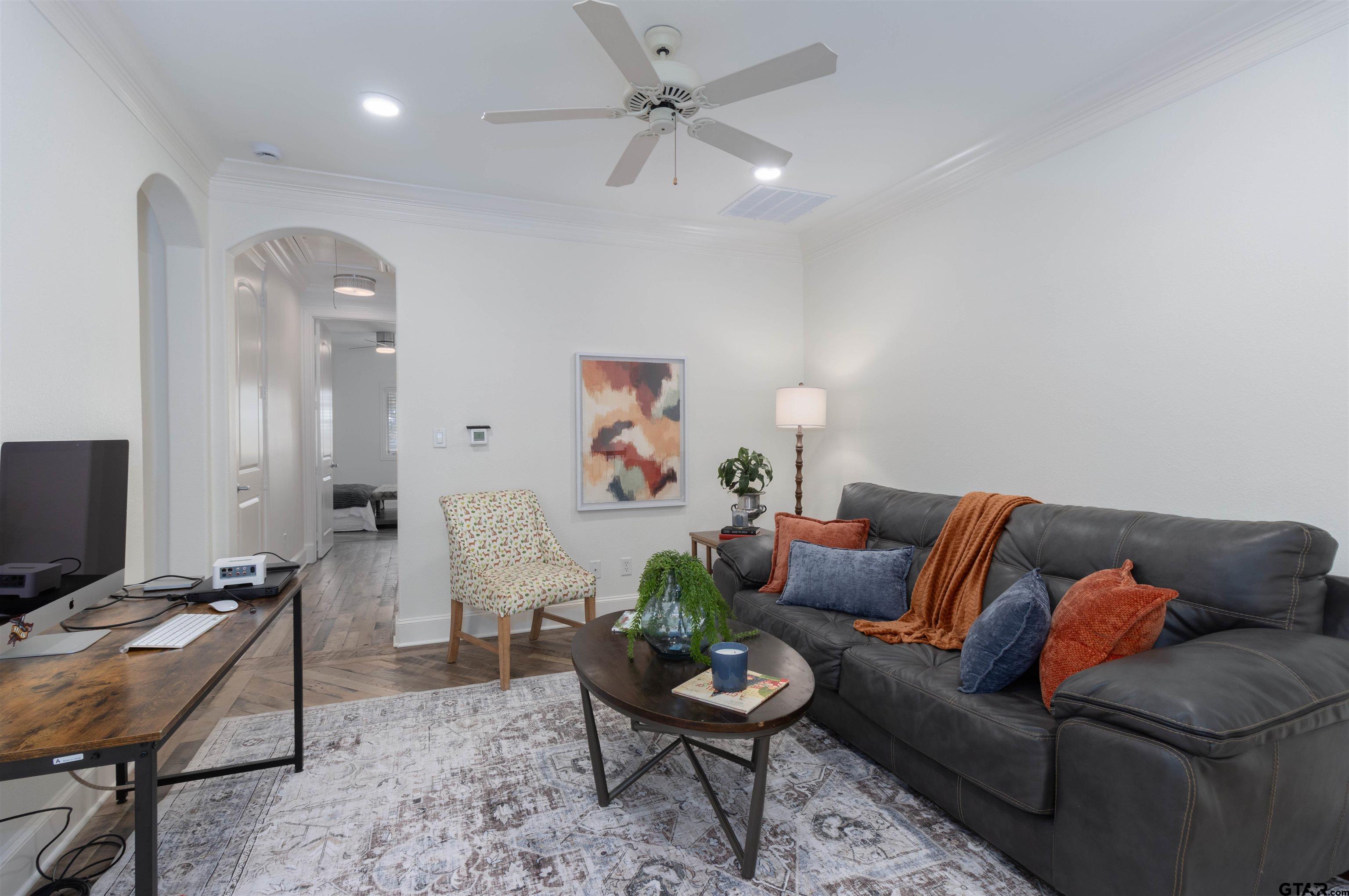 4534 Triggs Trace Tyler, TX 75709 - Photo 14 of 33 a living room with furniture a rug and a chandelier