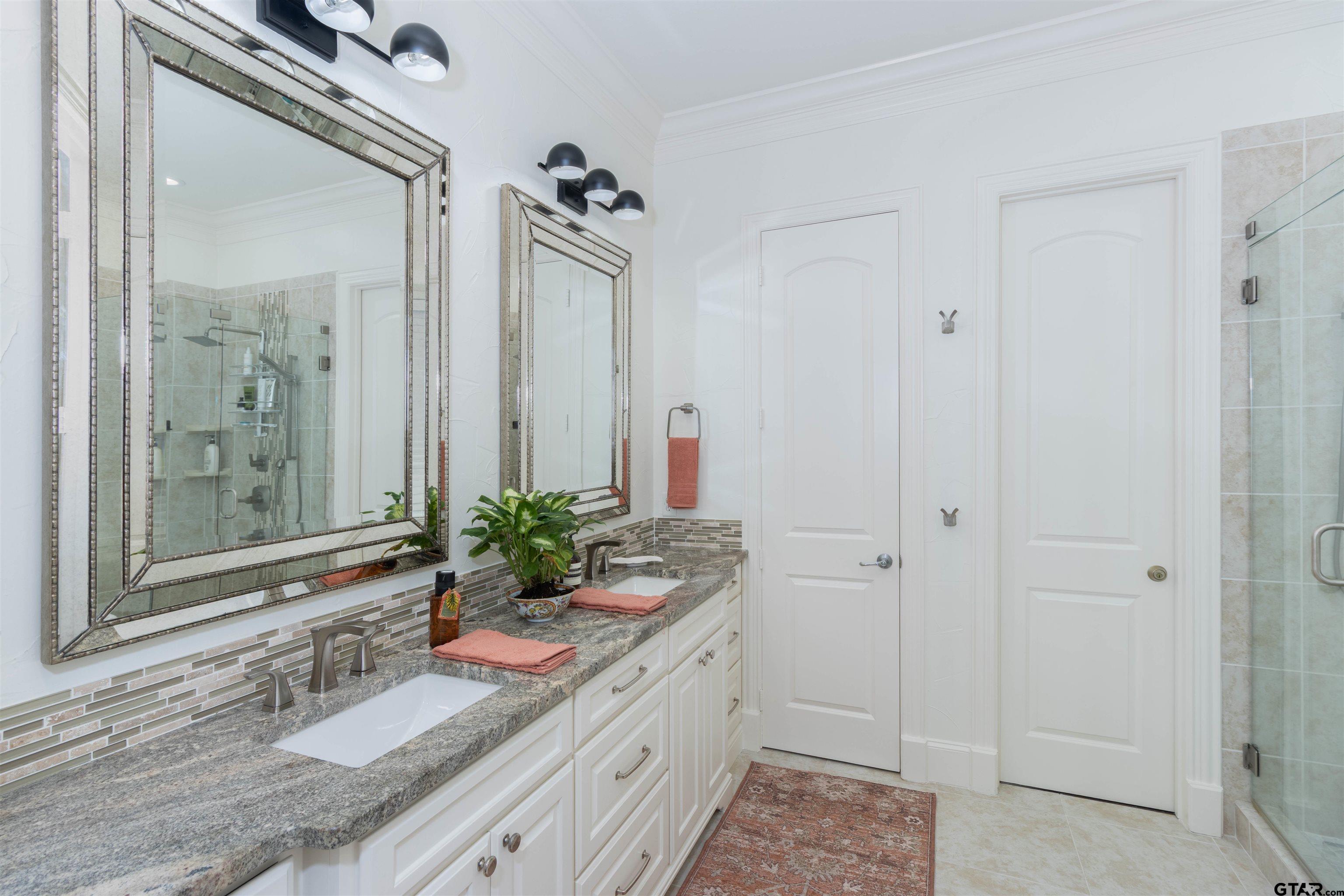 4534 Triggs Trace Tyler, TX 75709 - Photo 25 of 33 a bathroom with a granite countertop sink a mirror and a shower