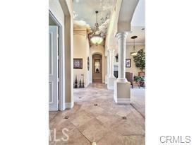 4069 Nancy Circle Corona, CA 92881 - Photo 26 of 73 a view of a hallway with dining area and chandelier