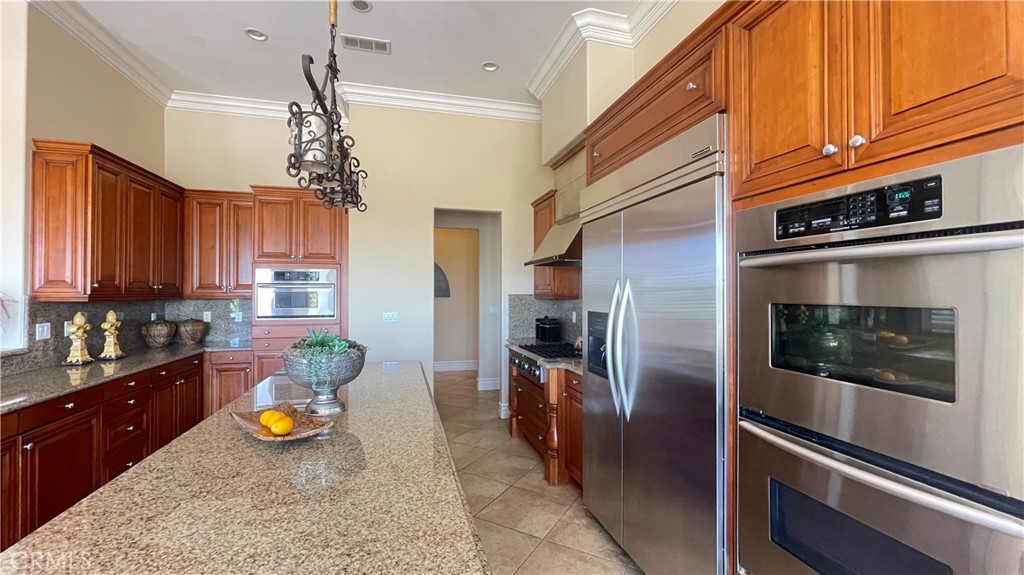 4069 Nancy Circle Corona, CA 92881 - Photo 41 of 73 a kitchen with stainless steel appliances granite countertop a refrigerator a stove and a sink