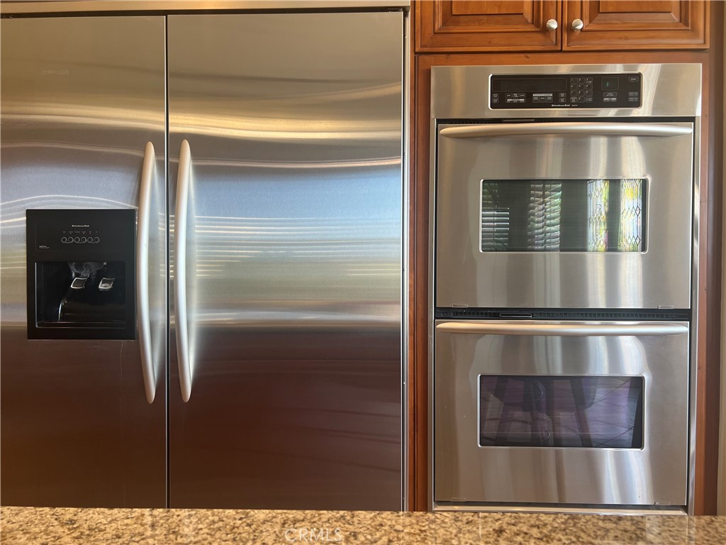 4069 Nancy Circle Corona, CA 92881 - Photo 42 of 73 a kitchen with cabinets and stainless steel appliances