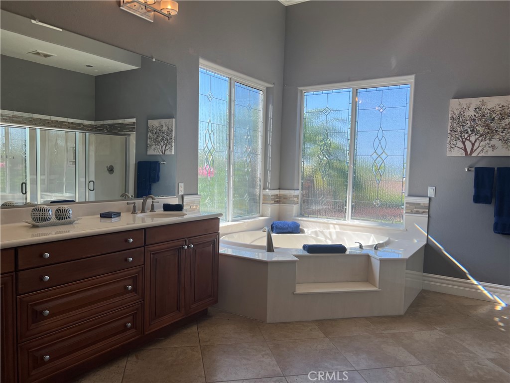 4069 Nancy Circle Corona, CA 92881 - Photo 45 of 73 a spacious bathroom with a granite countertop sink mirror and bathtub