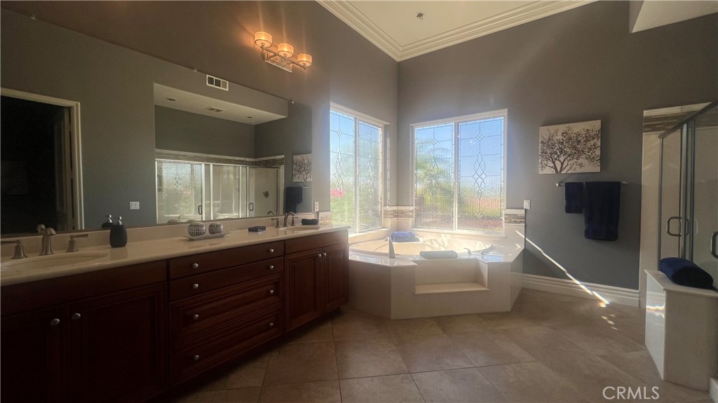 4069 Nancy Circle Corona, CA 92881 - Photo 47 of 73 a spacious bathroom with a tub sink double vanity granite and a mirror