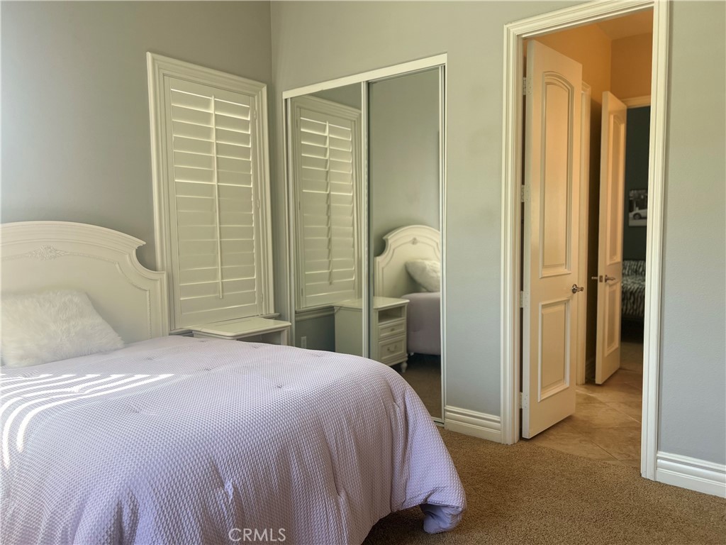 4069 Nancy Circle Corona, CA 92881 - Photo 54 of 73 a bedroom with a bed and a mirror