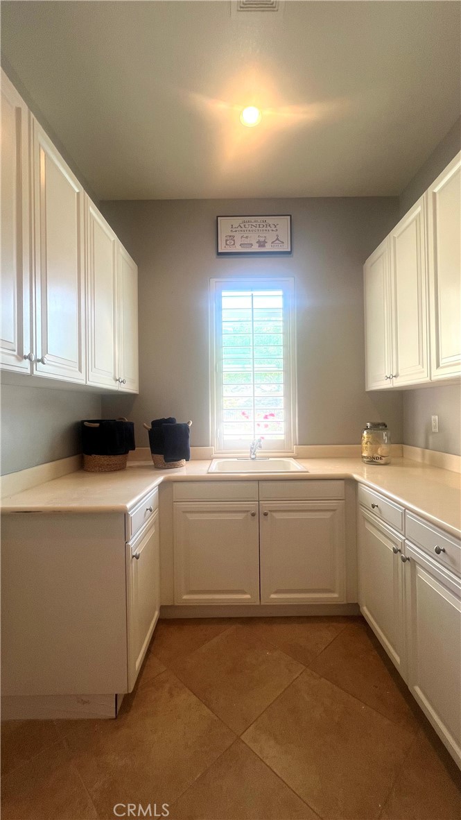4069 Nancy Circle Corona, CA 92881 - Photo 64 of 73 a kitchen with sink cabinets and window