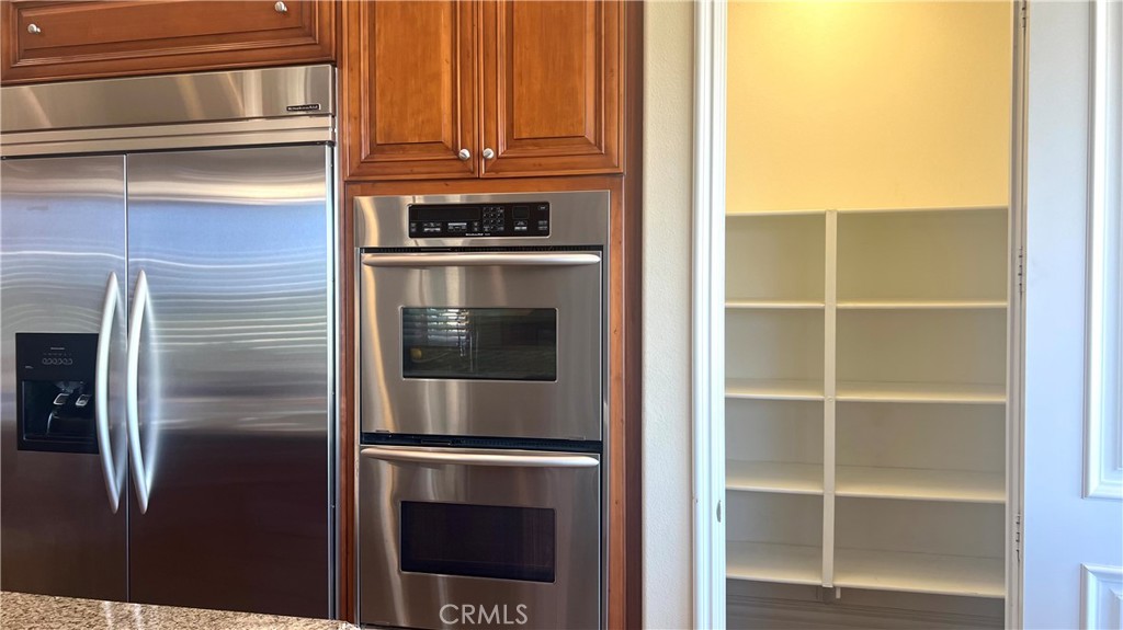 4069 Nancy Circle Corona, CA 92881 - Photo 68 of 73 a kitchen with a refrigerator and cabinets