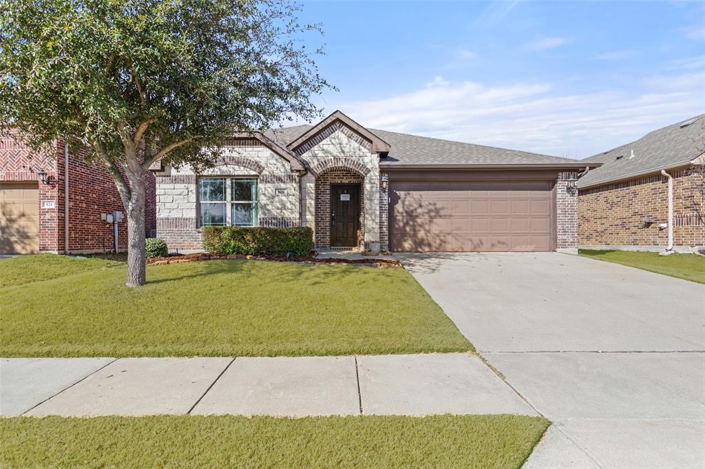 816 Harrison Lane Lavon, TX 75166 - Photo 1 of 40 a front view of a house with yard and garage