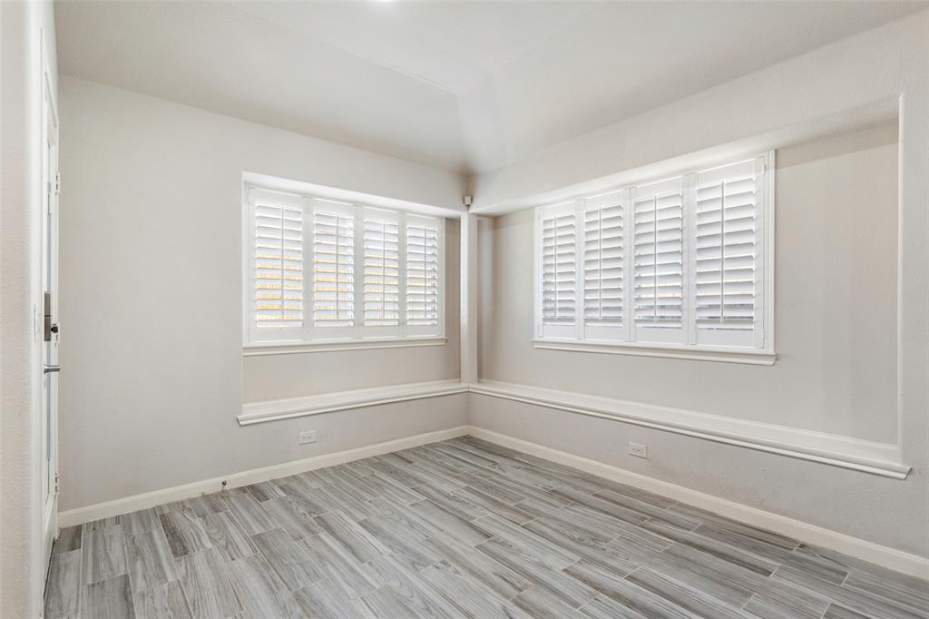 816 Harrison Lane Lavon, TX 75166 - Photo 14 of 40 a view of an empty room with wooden floor and a window