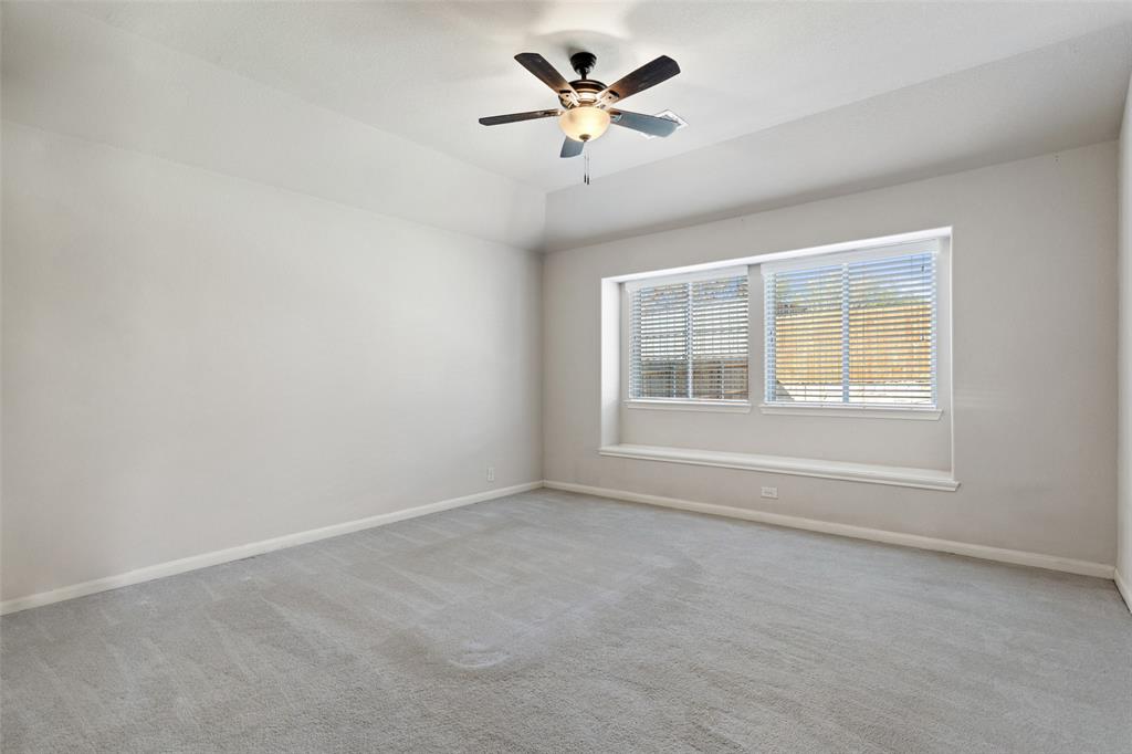 816 Harrison Lane Lavon, TX 75166 - Photo 19 of 40 an empty room with a window and a ceiling fan