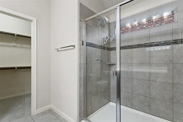 a bathroom with a glass shower door