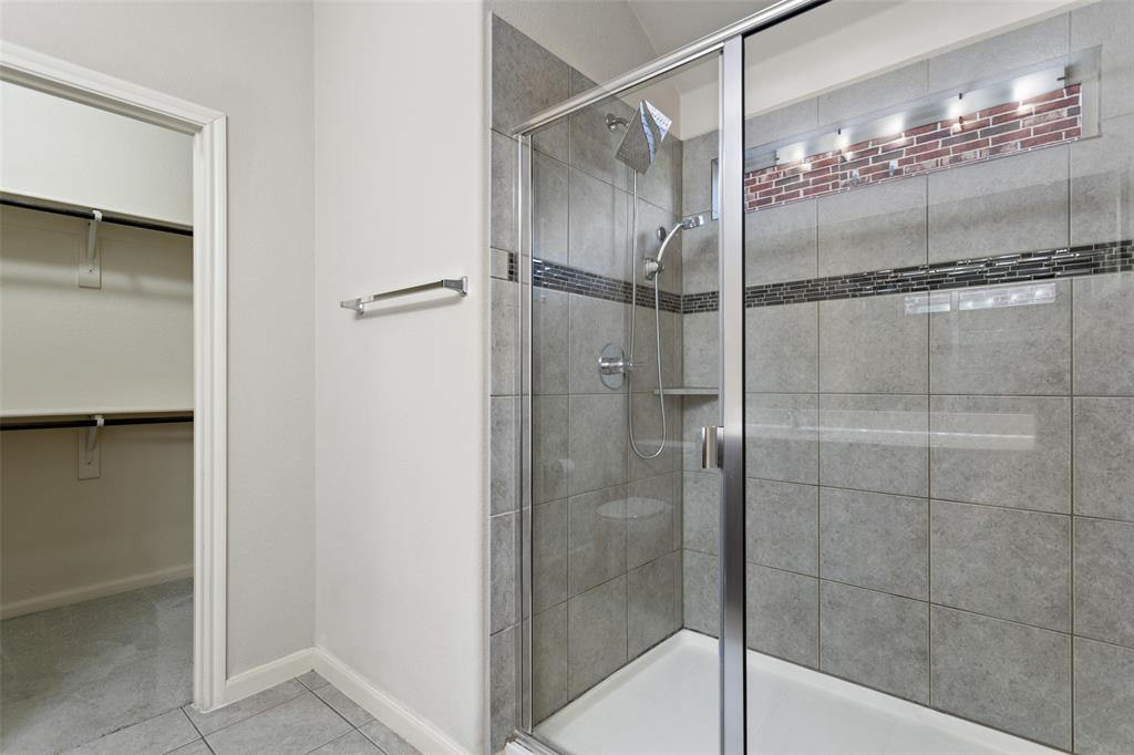 816 Harrison Lane Lavon, TX 75166 - Photo 21 of 40 a bathroom with a glass shower door