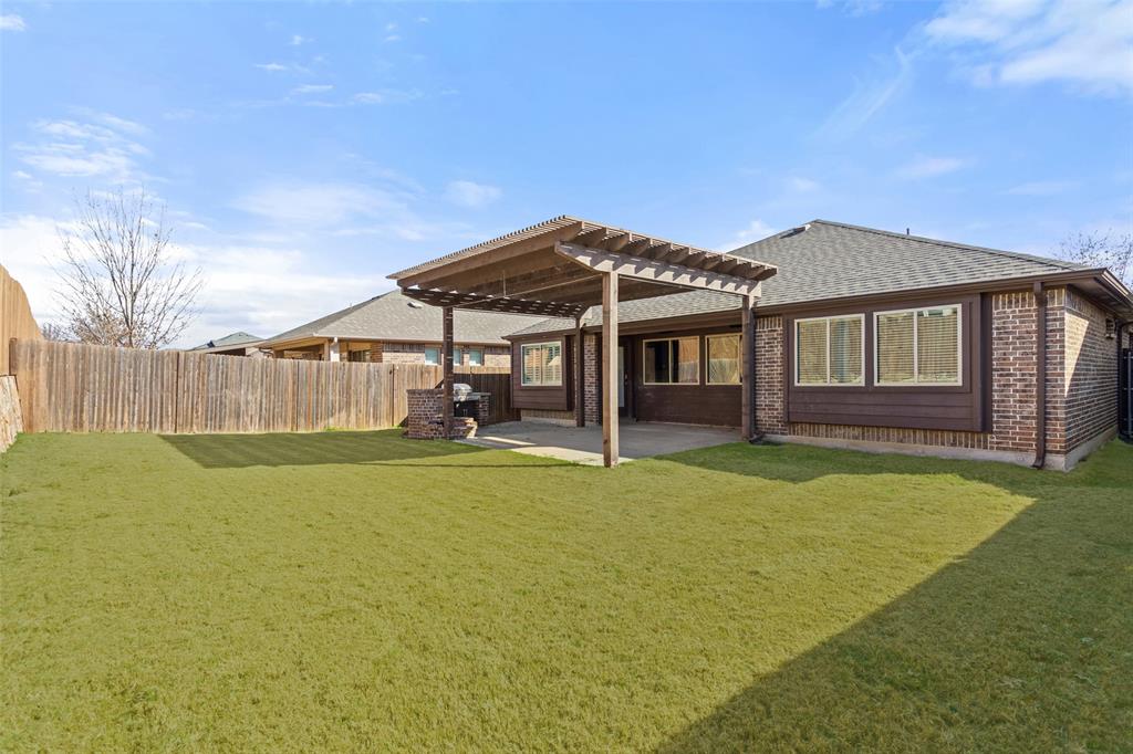 816 Harrison Lane Lavon, TX 75166 - Photo 29 of 40 a view of a house with a backyard and a patio