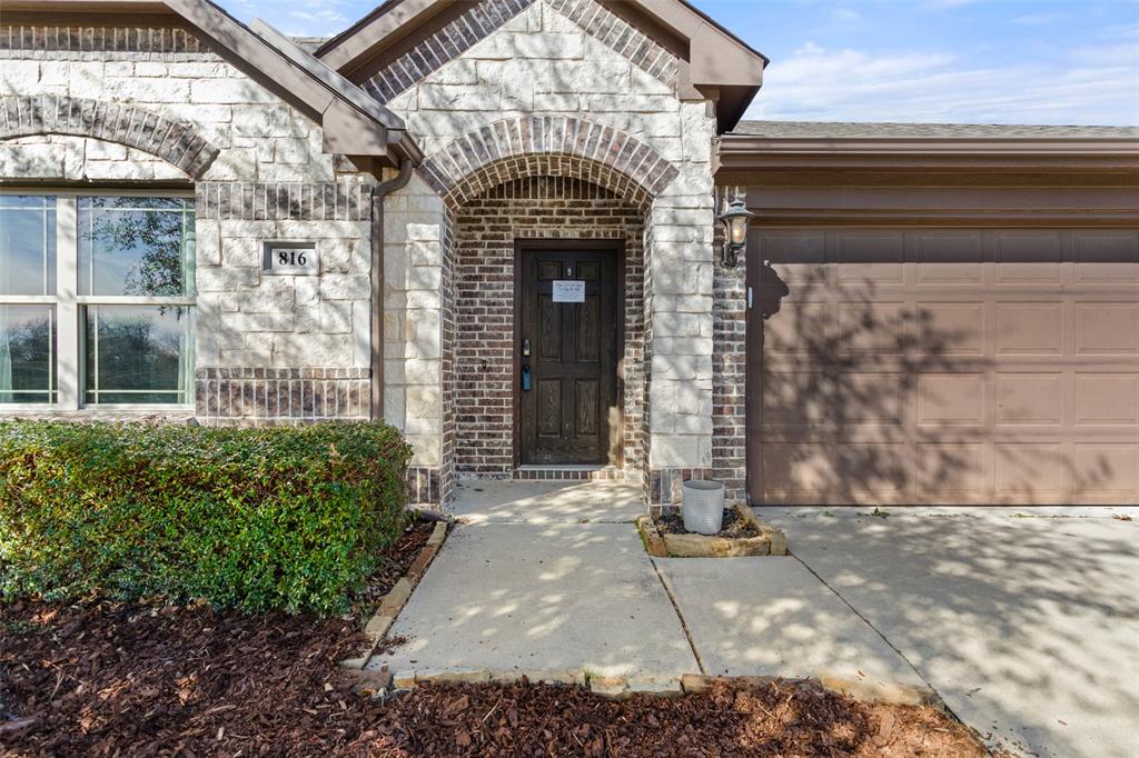 816 Harrison Lane Lavon, TX 75166 - Photo 3 of 40 a front view of a house with a garden