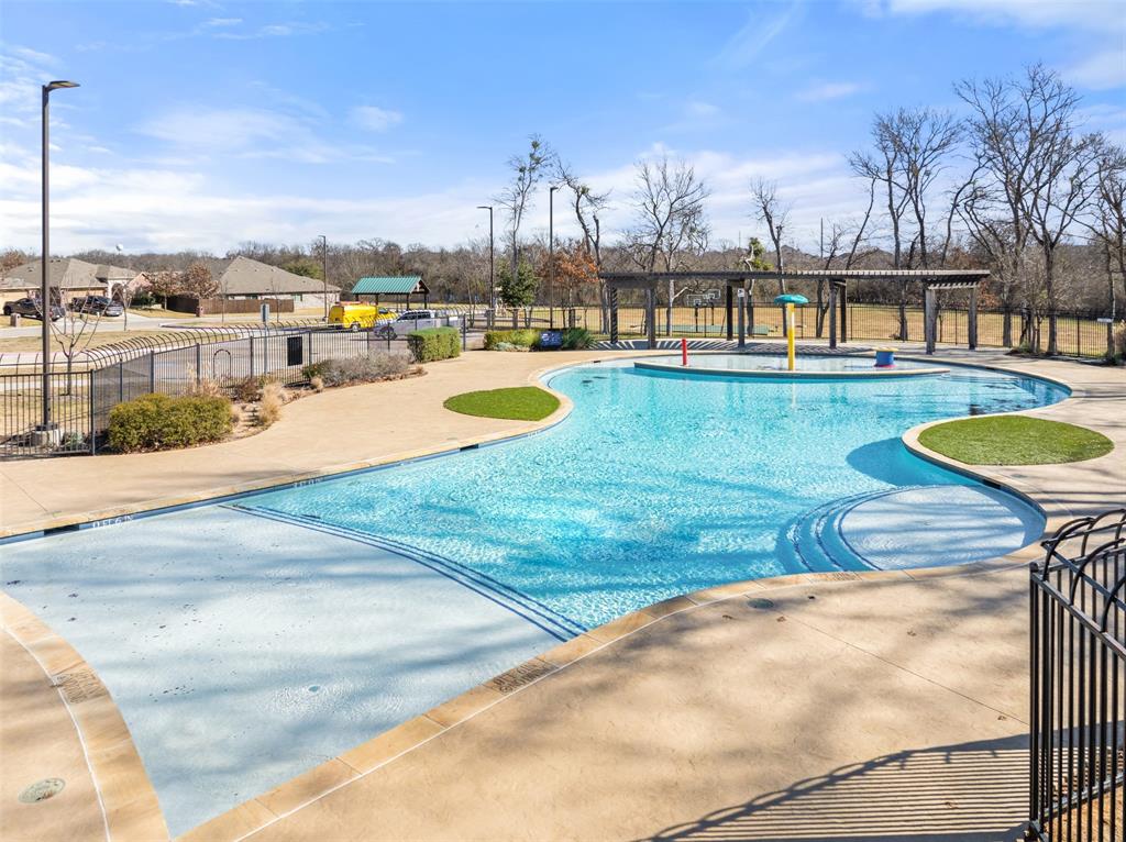 816 Harrison Lane Lavon, TX 75166 - Photo 38 of 40 a view of a swimming pool with a yard