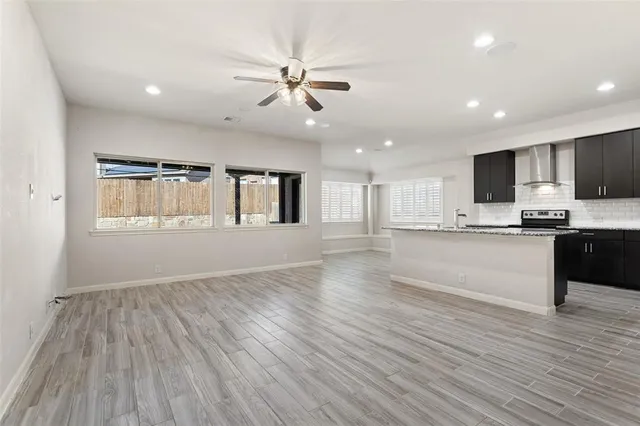 a view of kitchen with granite countertop cabinets and wooden floor