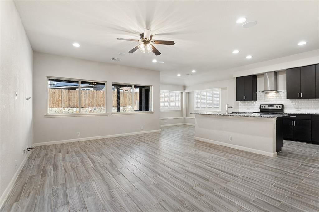 816 Harrison Lane Lavon, TX 75166 - Photo 5 of 40 a view of kitchen with granite countertop cabinets and wooden floor