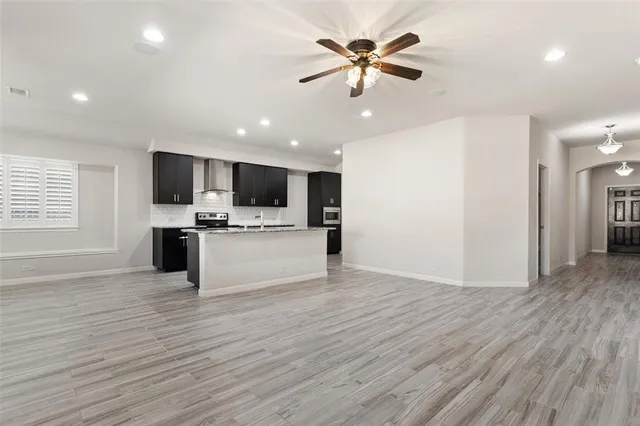 a view of kitchen with microwave and refrigerator