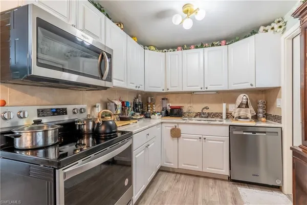 a kitchen with a stove and a white cabinets