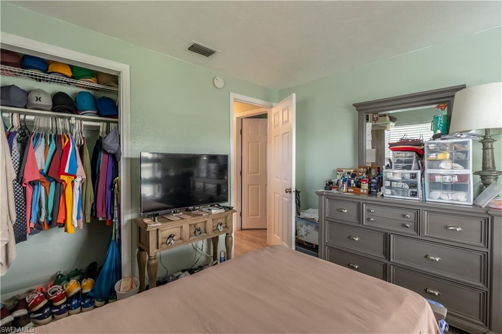 1360 5th Avenue North Naples, FL 34102 - Photo 13 of 45 a bedroom with a bed and a flat screen tv