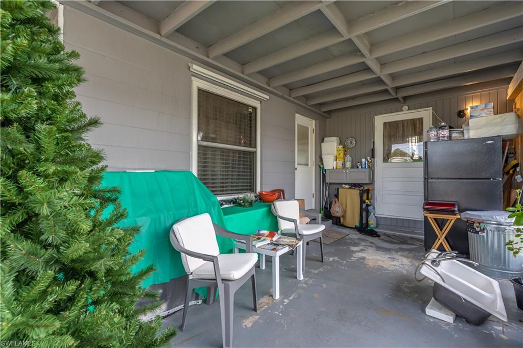 1360 5th Avenue North Naples, FL 34102 - Photo 18 of 45 a view of a dining room with furniture and a potted plant