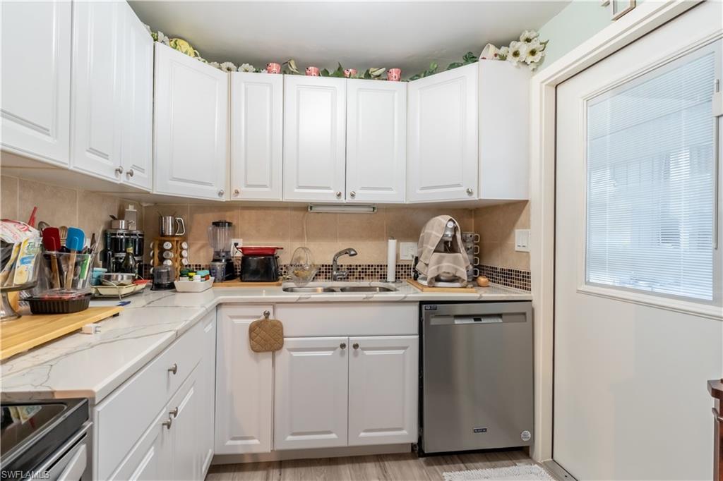 1360 5th Avenue North Naples, FL 34102 - Photo 2 of 45 a kitchen with cabinets appliances a sink and a counter top space