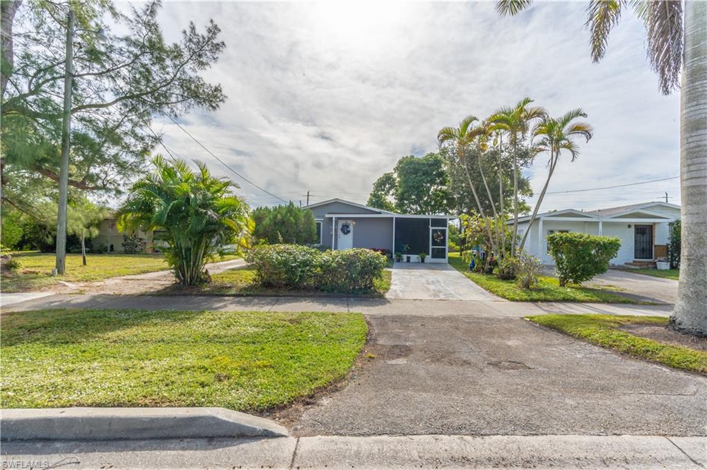 1360 5th Avenue North Naples, FL 34102 - Photo 22 of 45 a front view of a house with garden