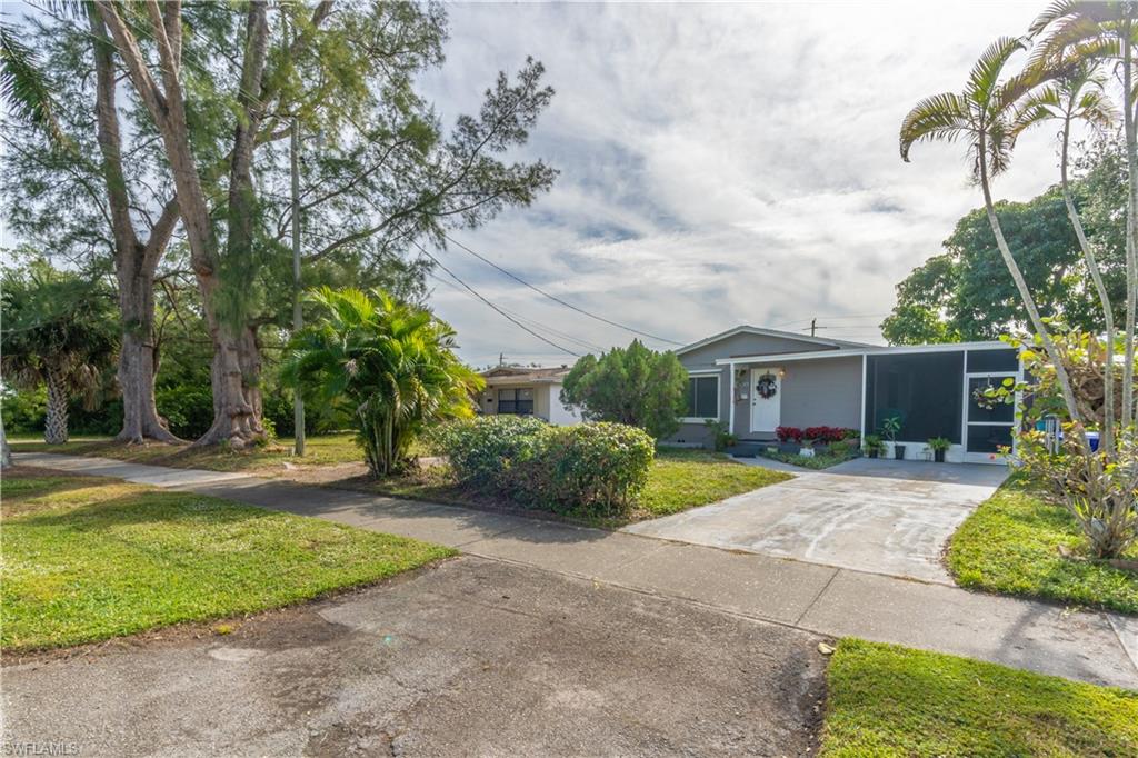 1360 5th Avenue North Naples, FL 34102 - Photo 23 of 45 a front view of a house with garden