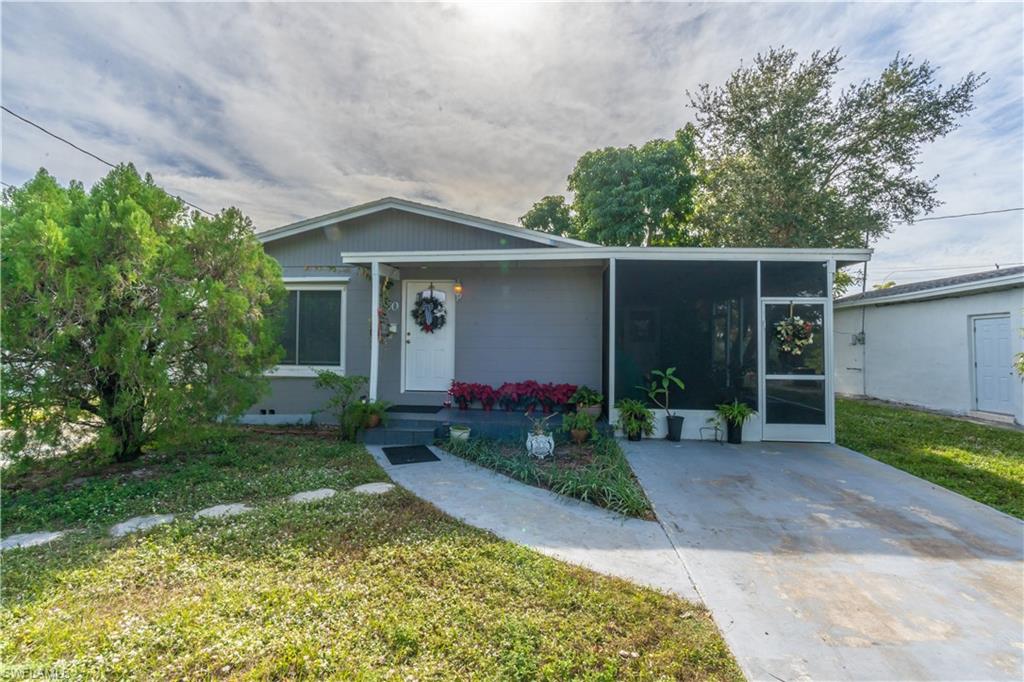 1360 5th Avenue North Naples, FL 34102 - Photo 26 of 45 a front view of a house with garden