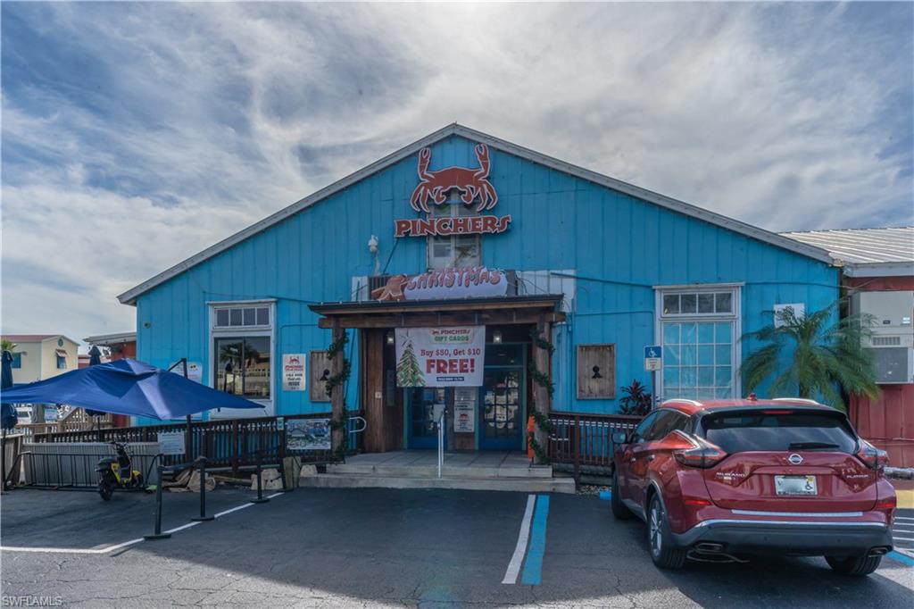 1360 5th Avenue North Naples, FL 34102 - Photo 42 of 45 a front view of a house with patio