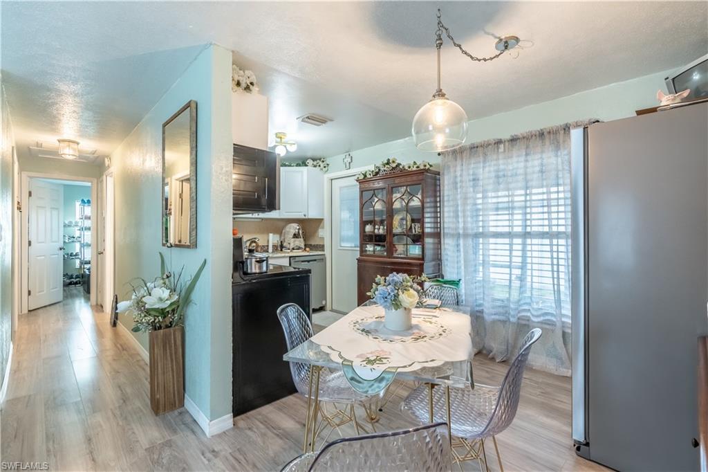 1360 5th Avenue North Naples, FL 34102 - Photo 7 of 45 a dining room with furniture window and wooden floor