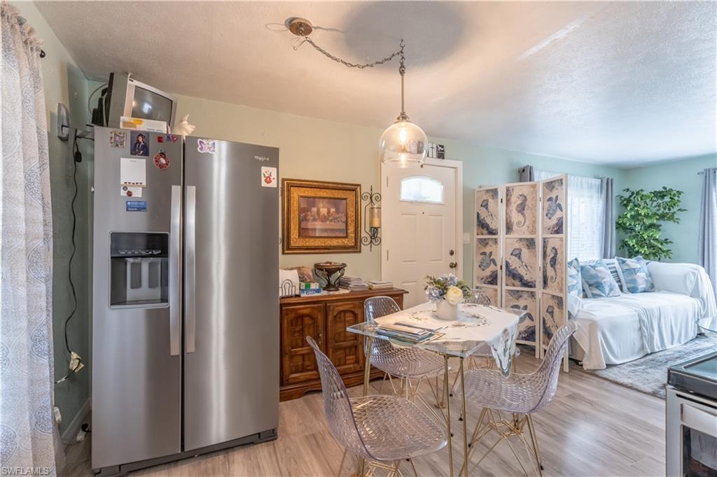 1360 5th Avenue North Naples, FL 34102 - Photo 8 of 45 a view of a dining room with furniture window and wooden floor