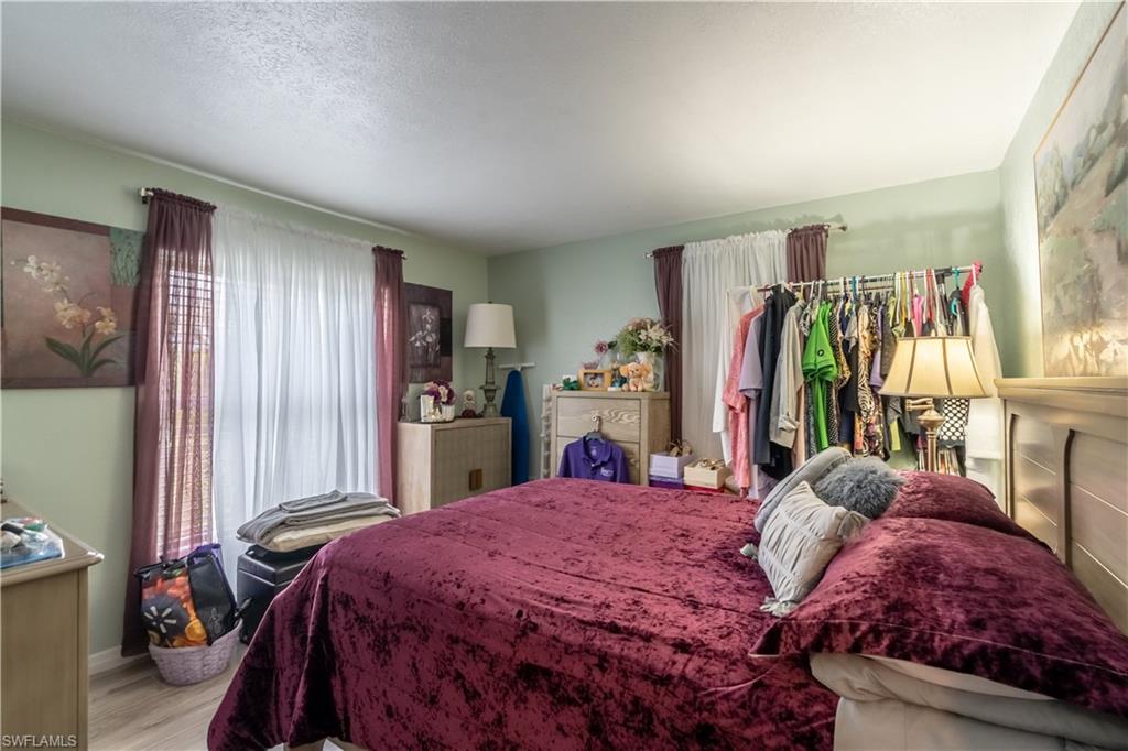 1360 5th Avenue North Naples, FL 34102 - Photo 10 of 45 a bed sitting in a bedroom next to a window