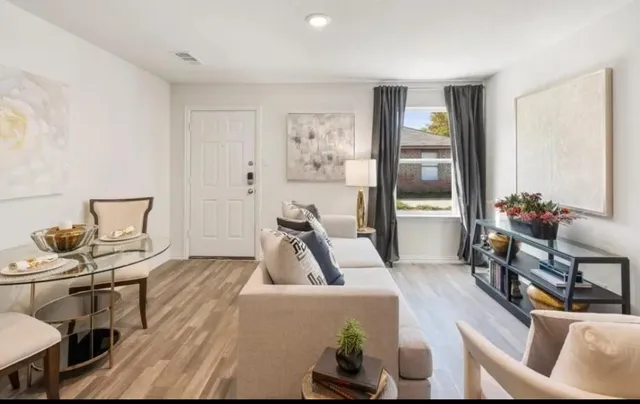 a living room with furniture and a flat screen tv