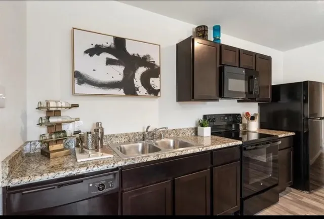 a kitchen with a sink and refrigerator