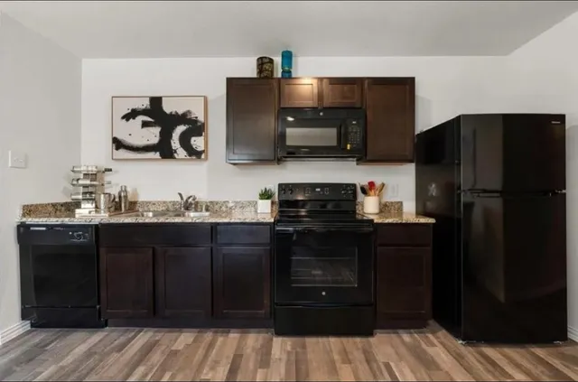 a kitchen with a refrigerator and cabinets