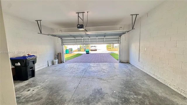 a view of a hallway to a livingroom with furniture