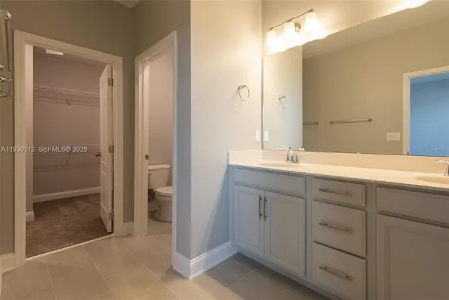 a bathroom with a double vanity sink and mirror