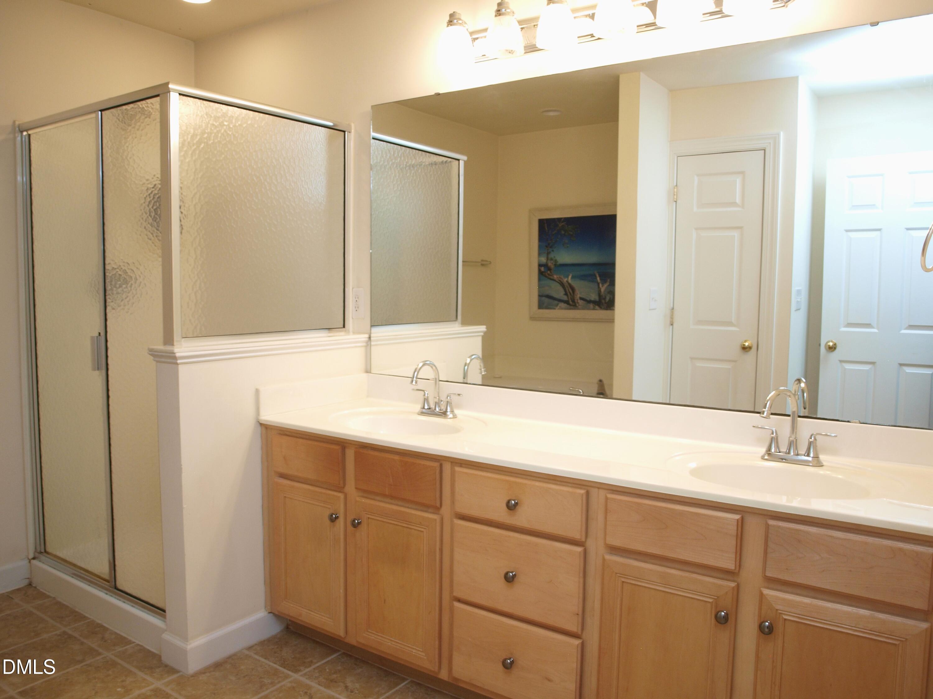 5206 Rio Grande Drive Raleigh, NC 27616 - Photo 23 of 37 a bathroom with a double vanity sink mirror and