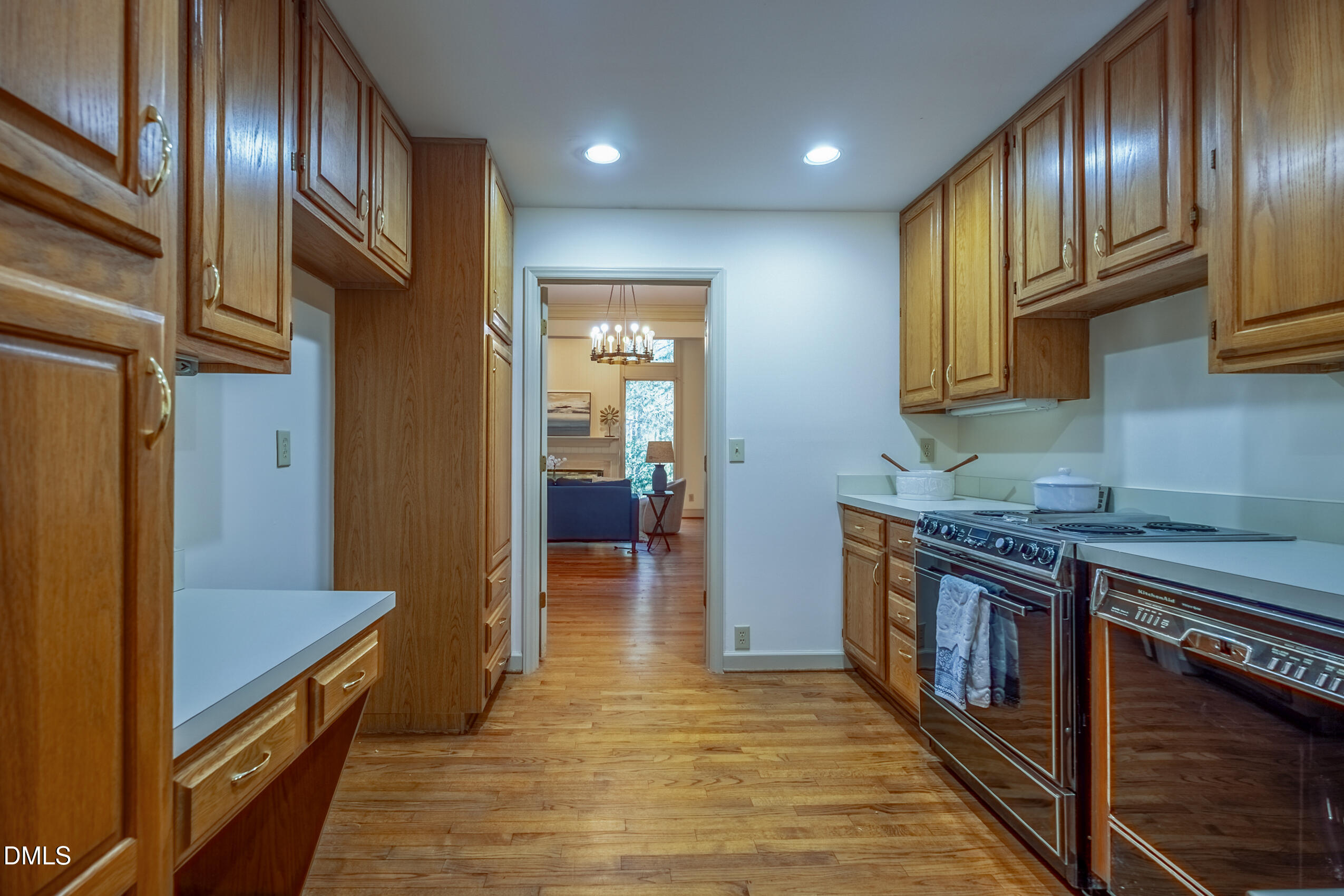 10 Innisfree Drive Durham, NC 27707 - Photo 13 of 36 a kitchen with stainless steel appliances granite countertop a refrigerator a stove and a wooden floors