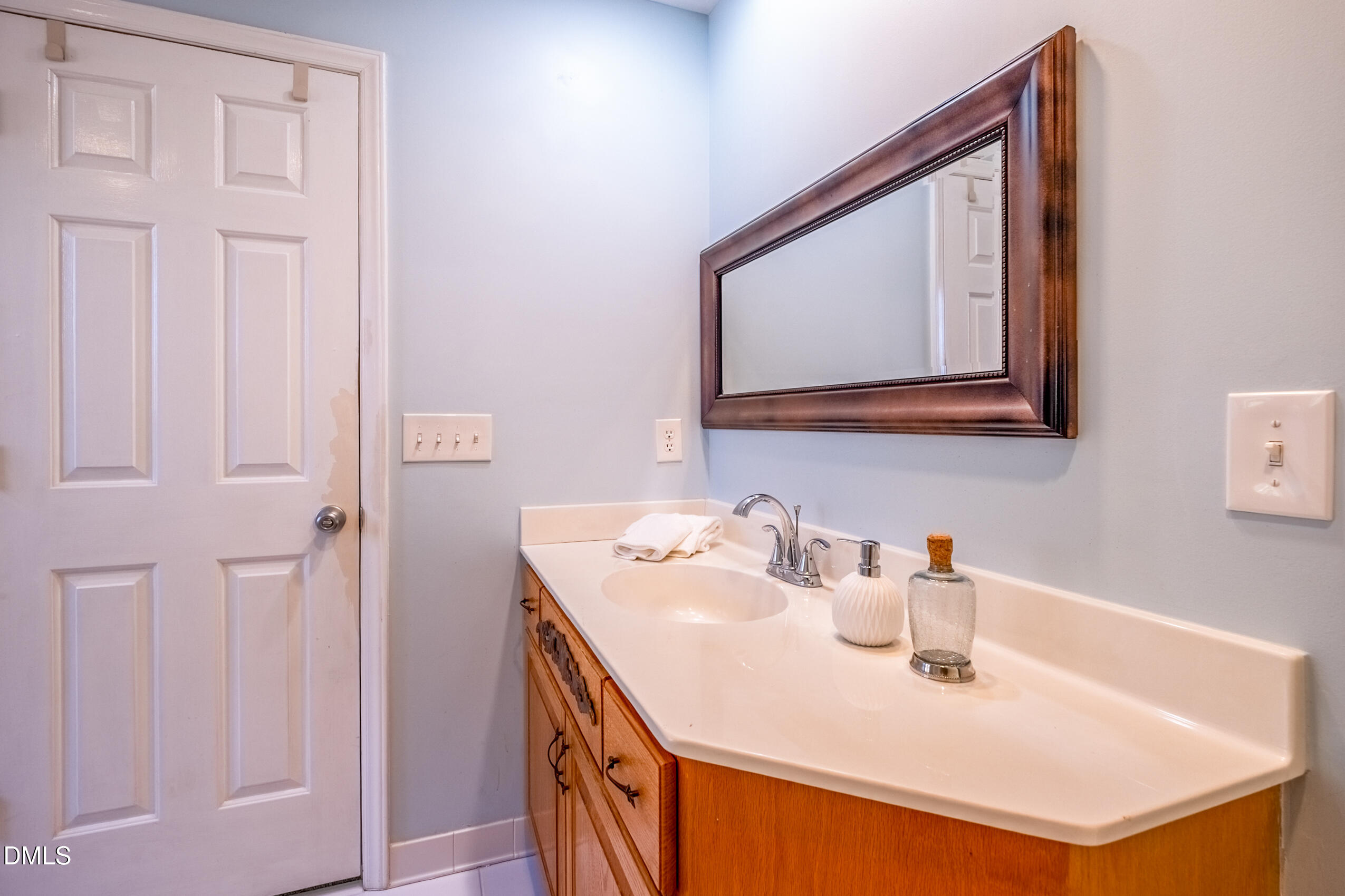 10 Innisfree Drive Durham, NC 27707 - Photo 30 of 36 a bathroom with a sink a vanity and a mirror