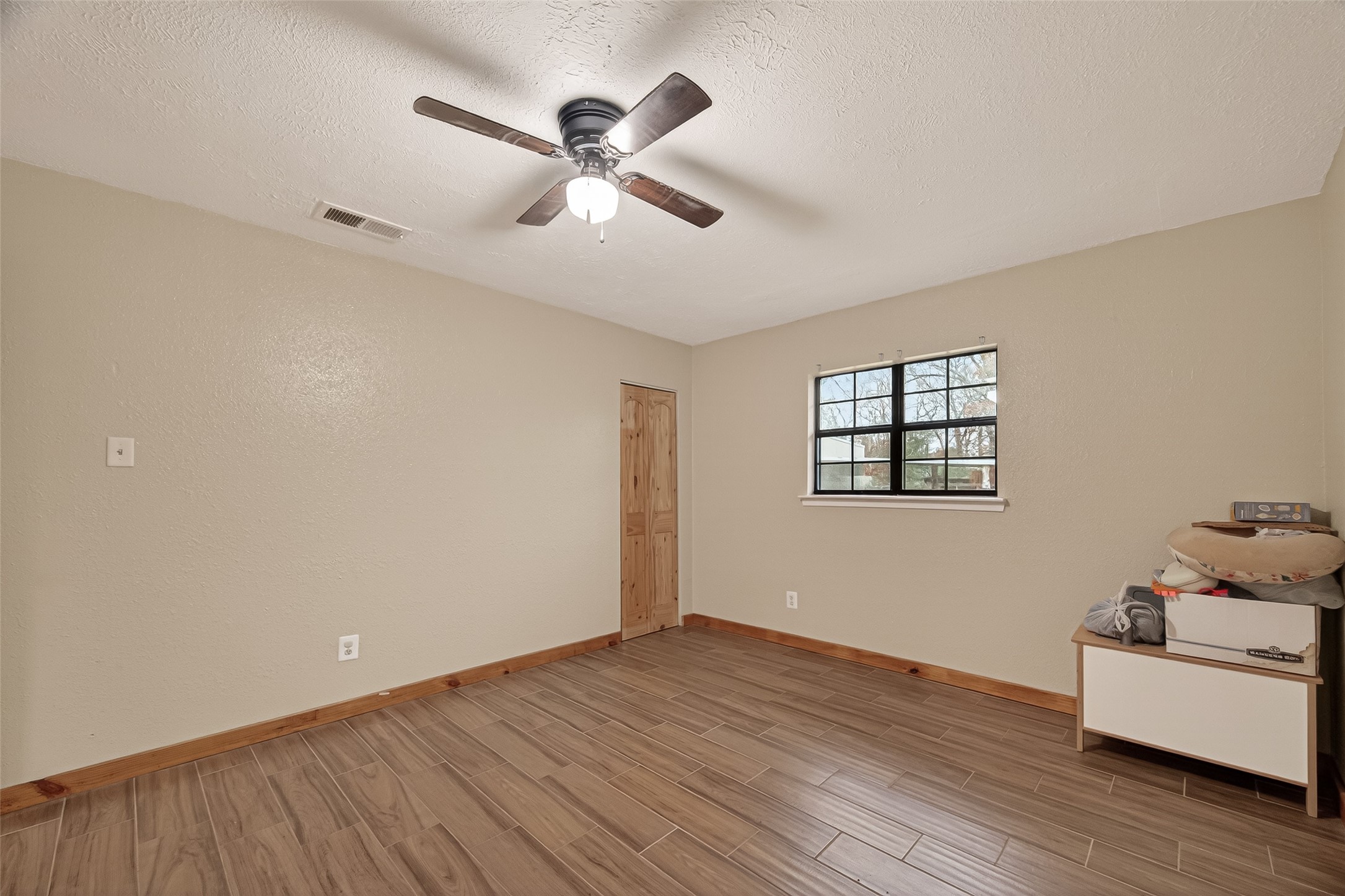 588 County Road 2307 Cleveland, TX 77327 - Photo 13 of 24 a view of empty room with wooden floor and fan