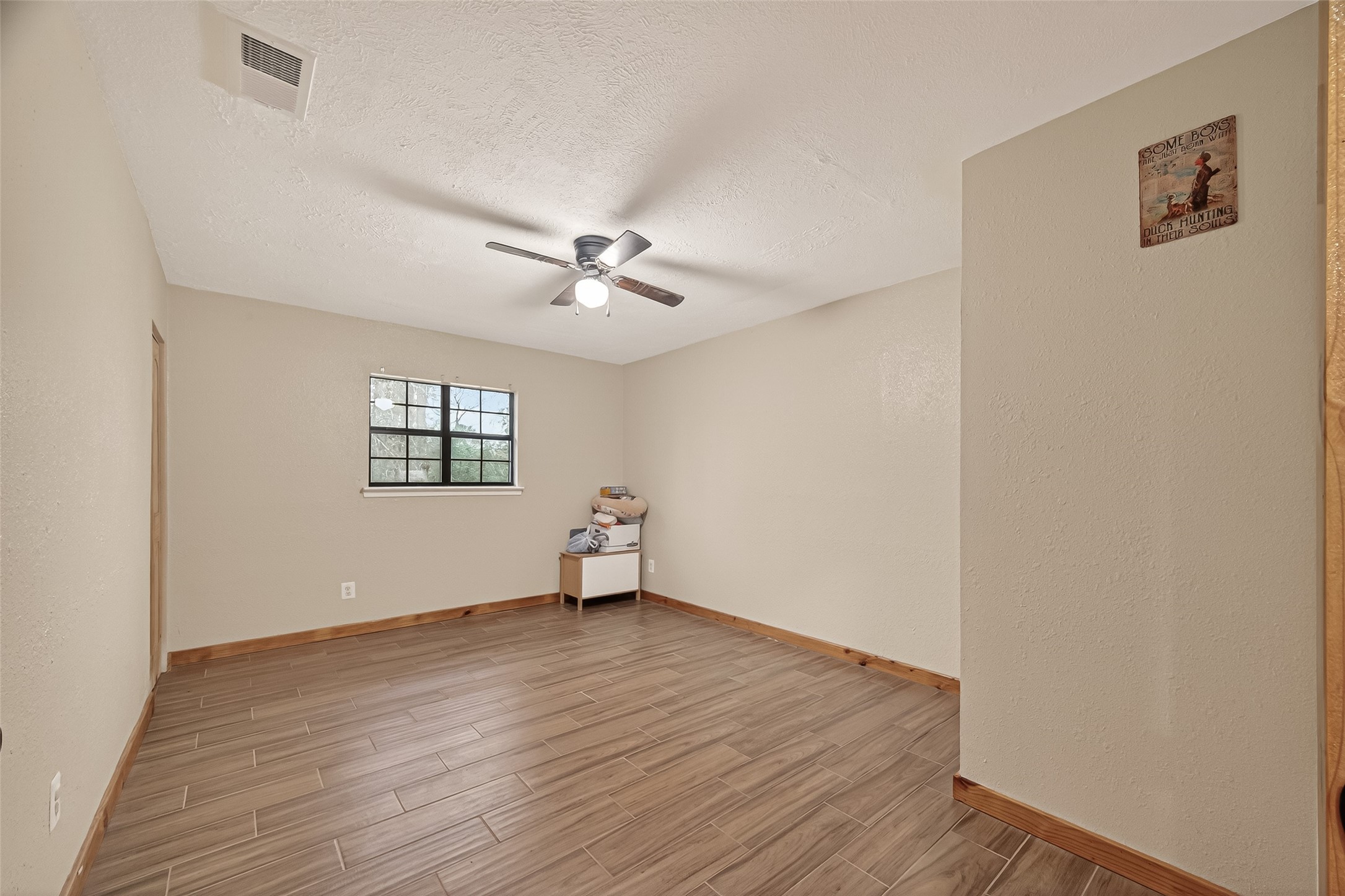 588 County Road 2307 Cleveland, TX 77327 - Photo 14 of 24 a view of an empty room with wooden floor