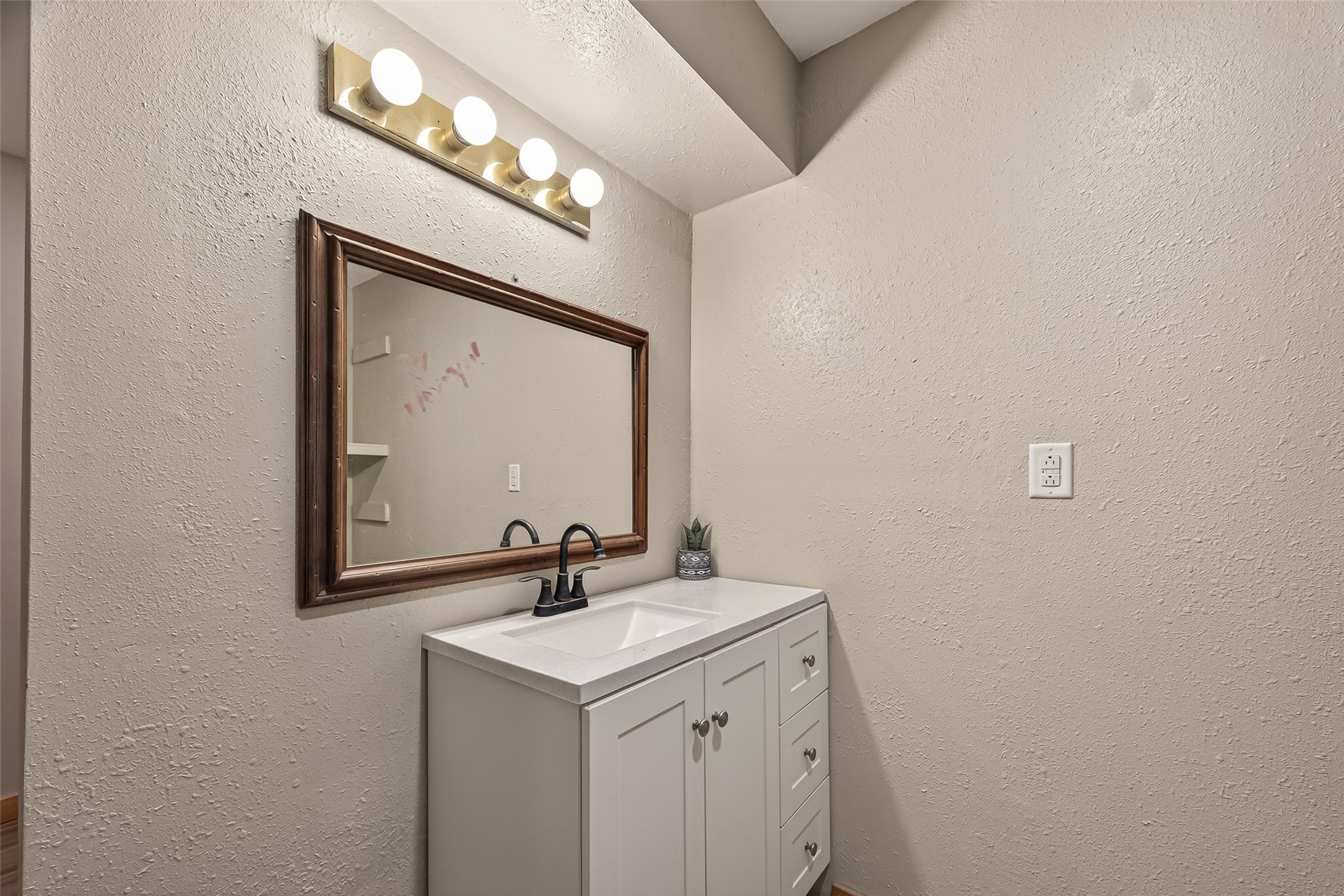 588 County Road 2307 Cleveland, TX 77327 - Photo 19 of 24 a bathroom with a sink and a mirror